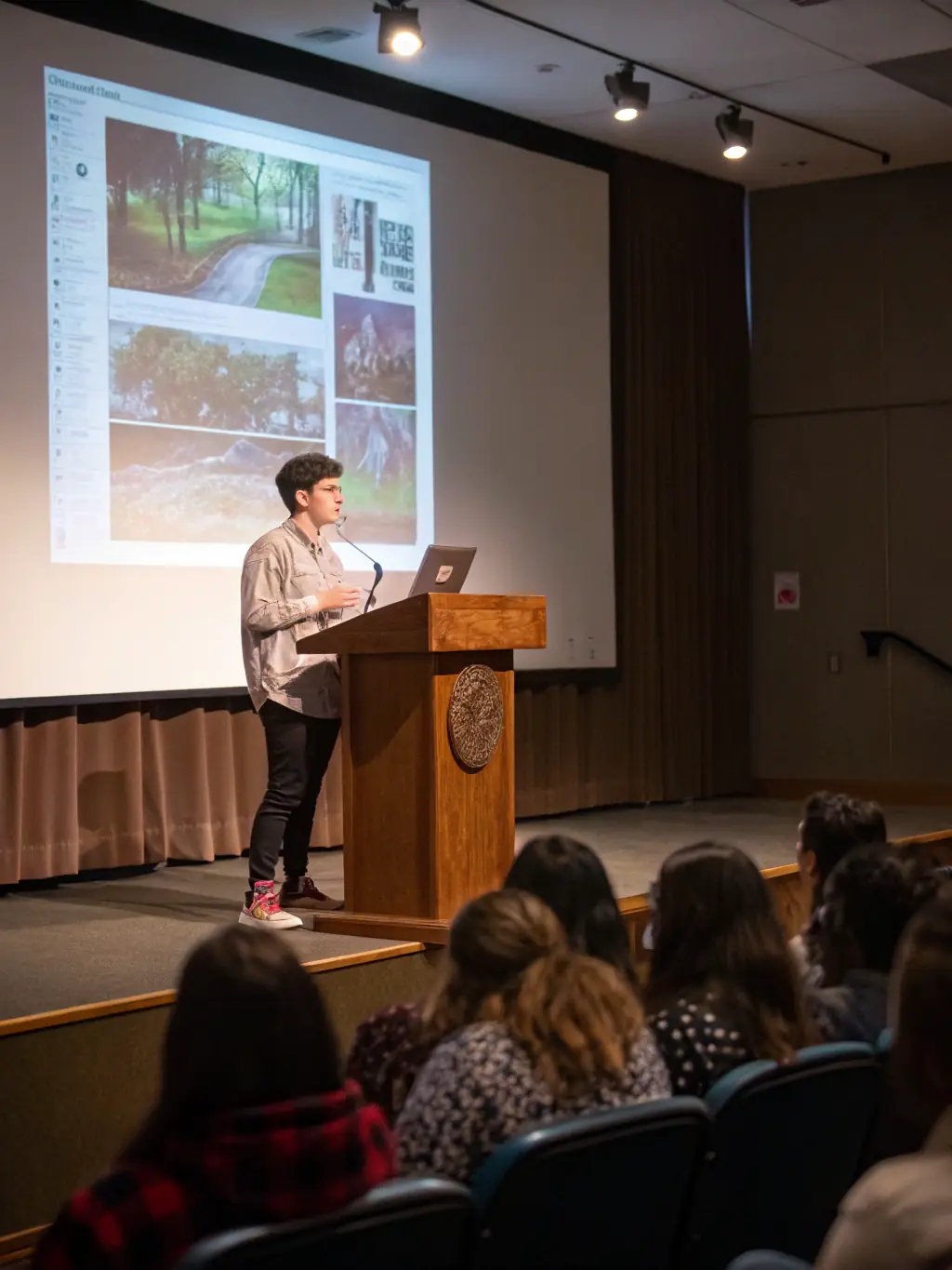 A student confidently presenting their thesis in front of a panel, showcasing the successful thesis development support offered by Project Pro Help.